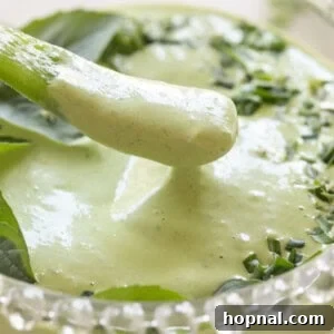 Dipping a pepper into green goddess dip.