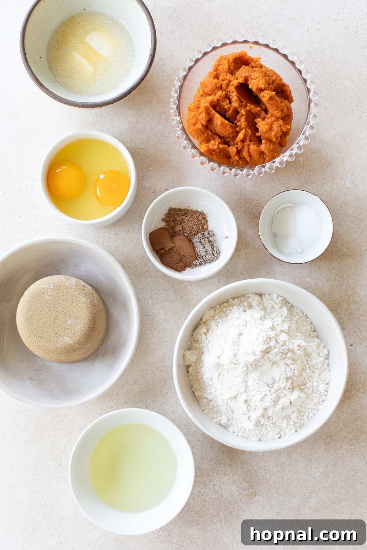 Warm Spiced Pumpkin Crumb Cake 3 A collection of fresh ingredients laid out on a table, ready to be combined to make a homemade pumpkin coffee cake.