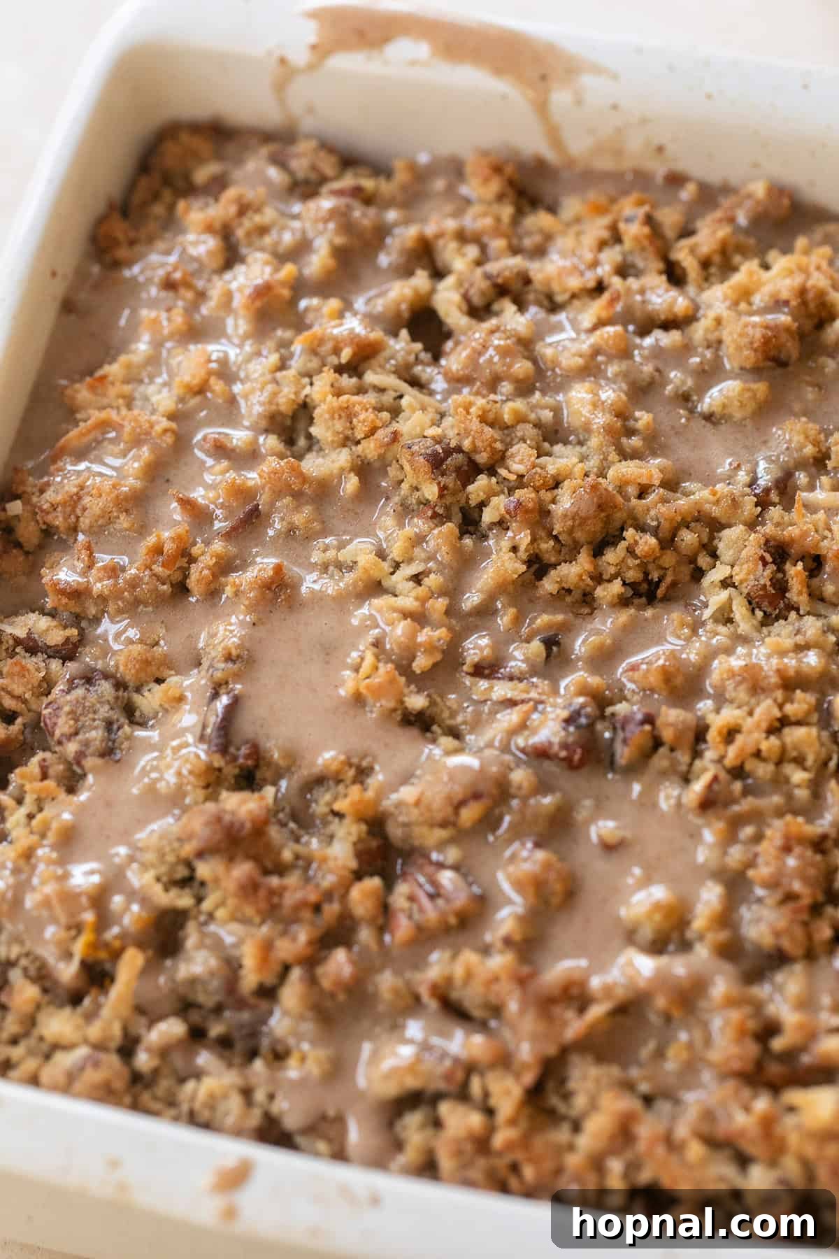 Warm Spiced Pumpkin Crumb Cake 8 An inviting overhead view of a freshly baked pumpkin crumb cake, beautifully adorned with a cinnamon, nutmeg, and cardamom glaze, ready to be enjoyed.