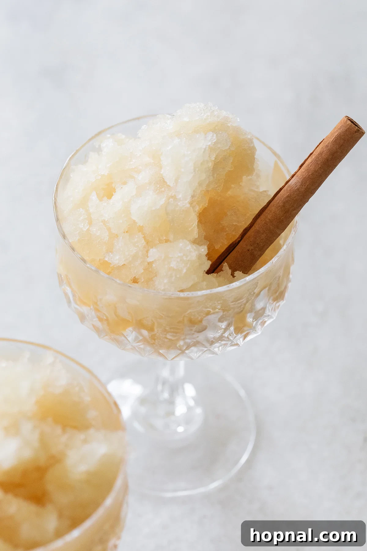Frozen apple cider slushie with cinnamon stick.