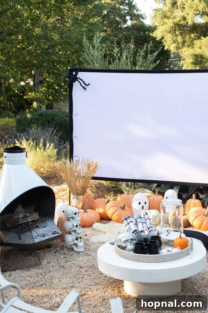 Halloween movie night with pumpkins, a screen and Halloween decor.