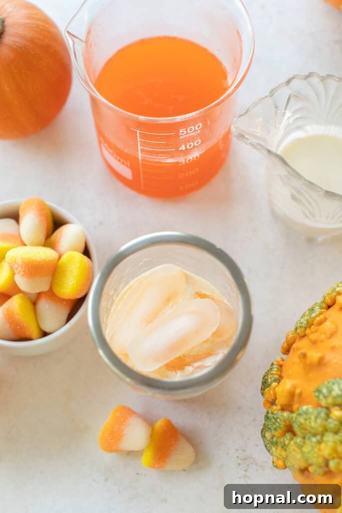 Ingredients for a Candy Corn Martini laid out on a surface.