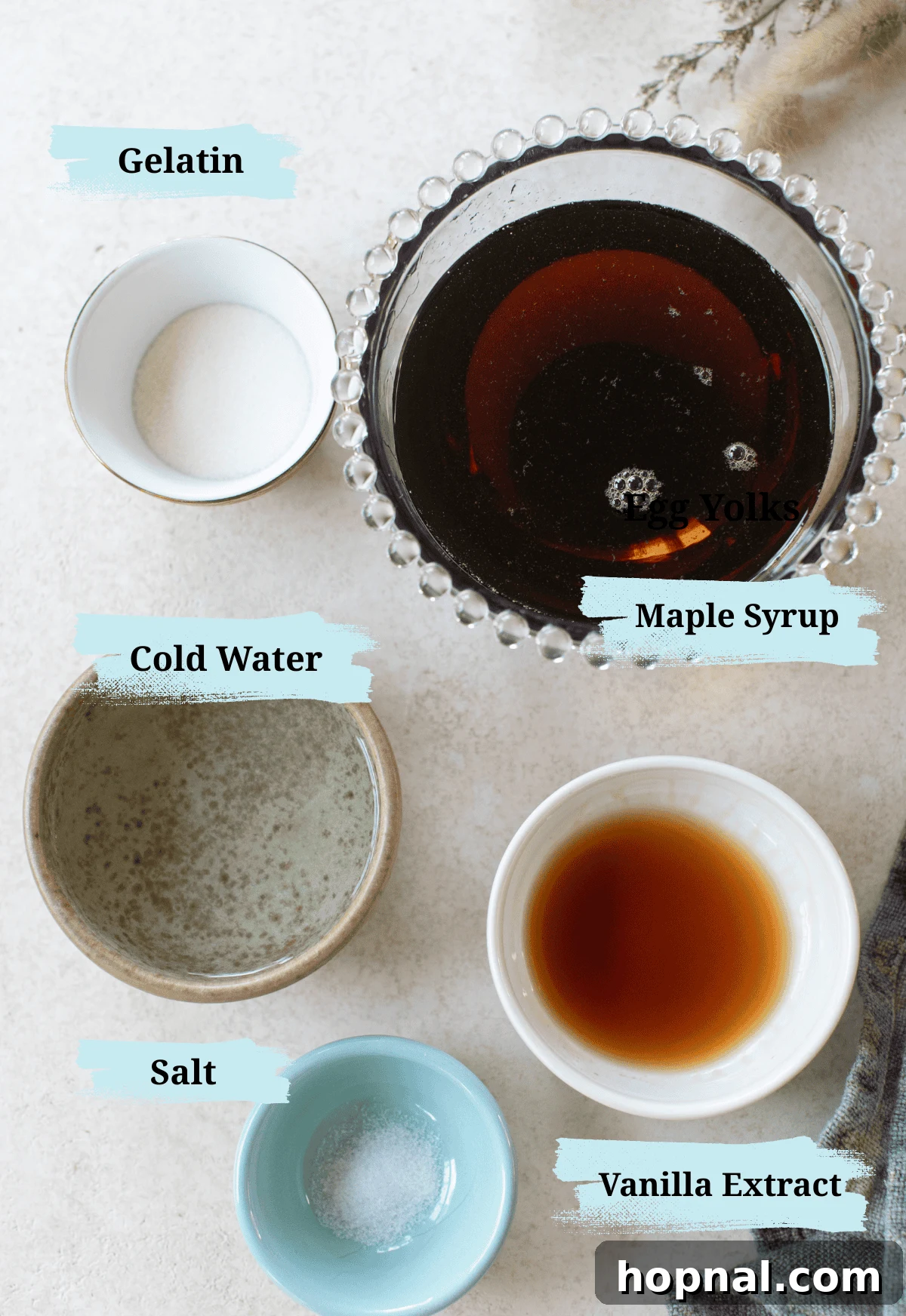 Pillowy Maple Dreams 3 Ingredients in bowls to make maple syrup marshmallows, including gelatin, maple syrup, vanilla extract, and salt.