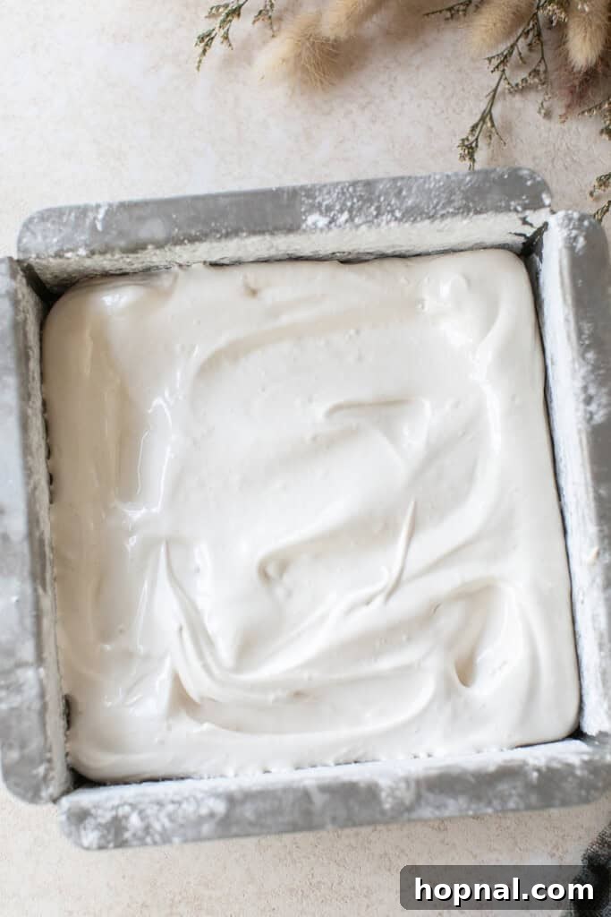 Pillowy Maple Dreams 6 Four ingredient maple syrup marshmallows setting in a pan, before cutting.