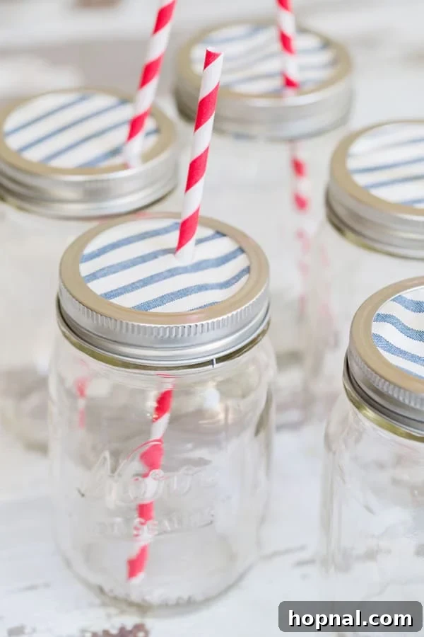 Party Perfect Festive Jar Decor 2 Decorative Ball canning jars adorned with colorful fabric tops and eco-friendly straws, perfectly arranged for a vibrant outdoor party setting.