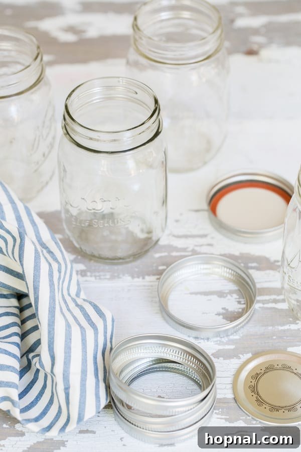 Party Perfect Festive Jar Decor 4 A stack of clean, empty Ball canning jars with their two-part lids, ready for a fun DIY party craft.