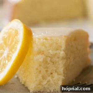 Slice of a super moist lemon olive oil cake with glaze.