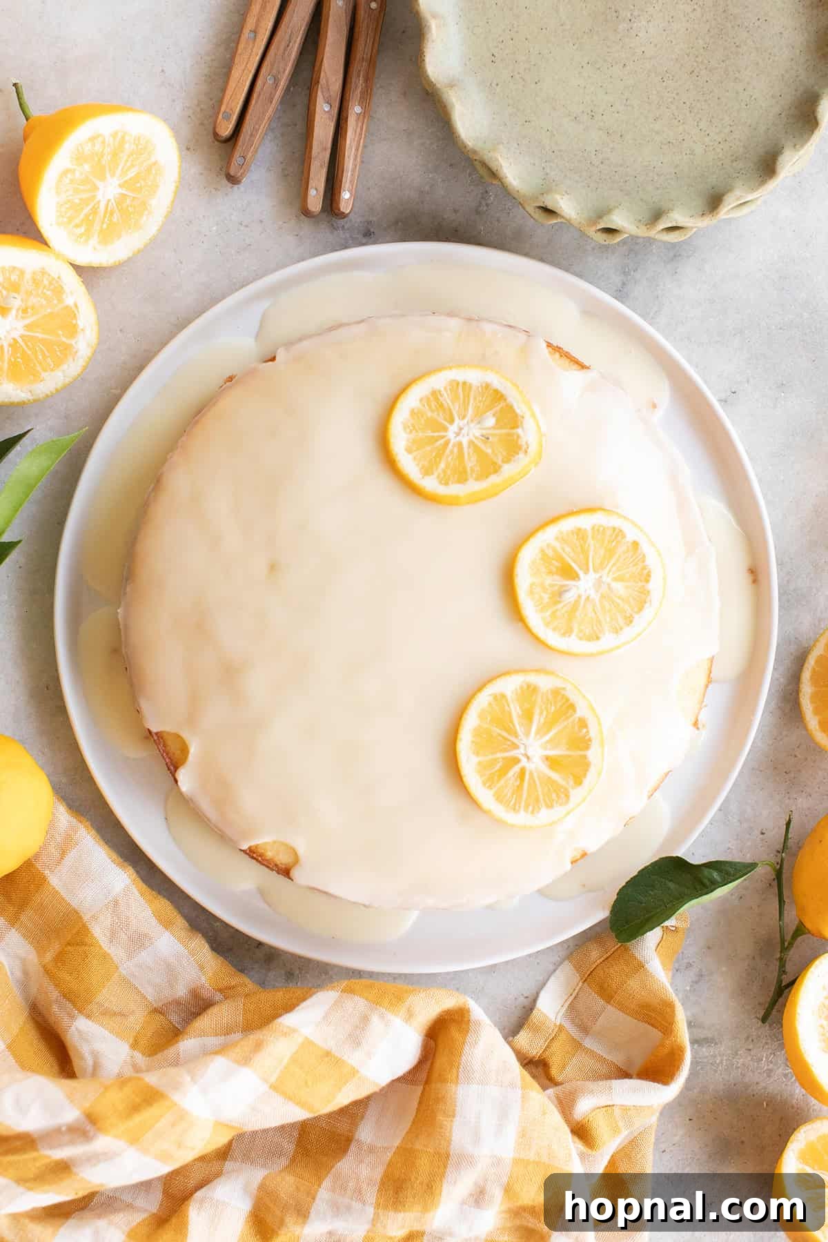 Super moist lemon olive cake with a lemon olive oil glaze and sliced lemons.