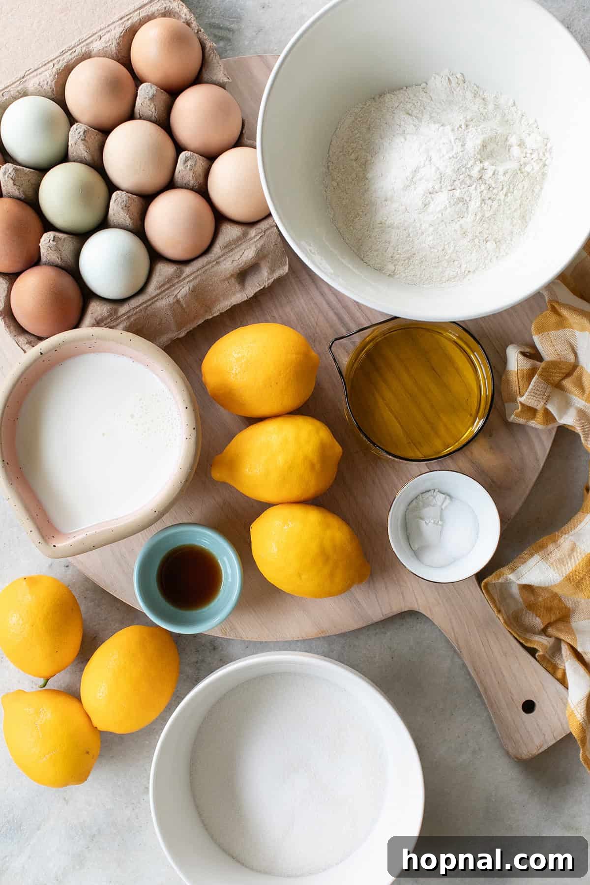 Ingredients to make a lemon olive oil cake: Olive oil, whole milk, eggs, flour, lemon juice and lemon zest.