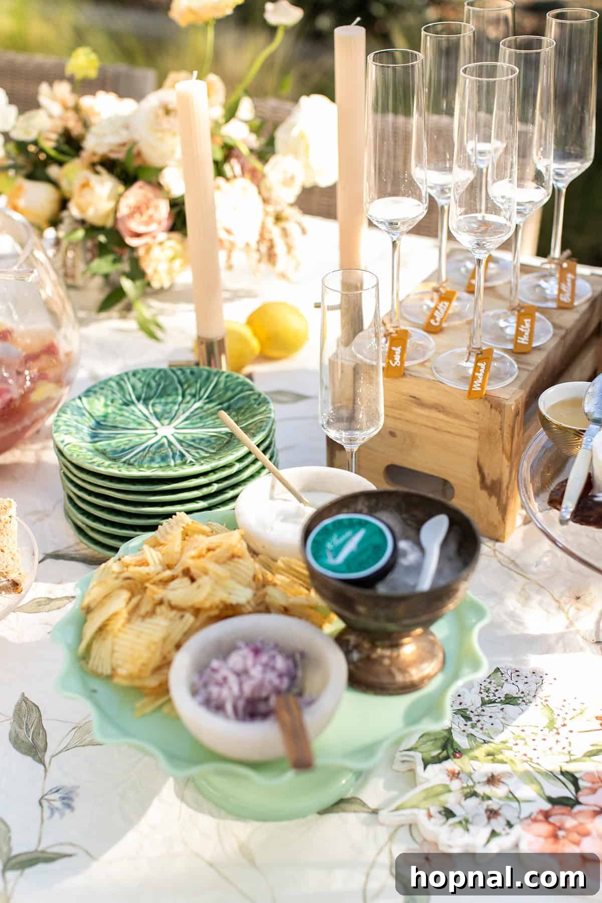 Exquisite caviar platter adorned with candles and fresh flowers, perfectly set for a sophisticated champagne garden party.