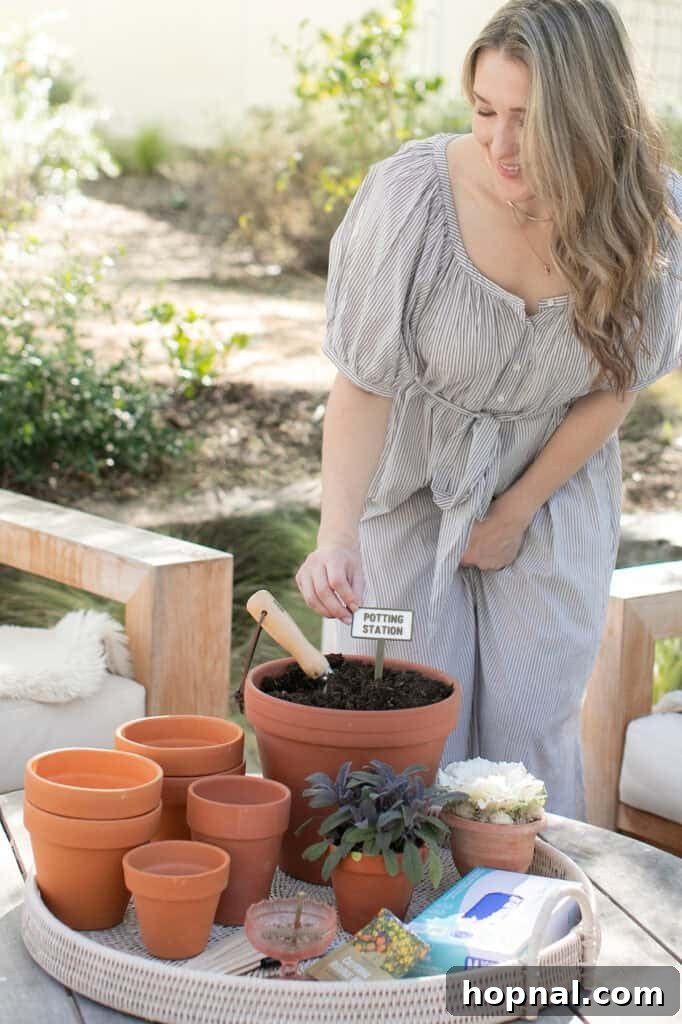 Eden Passante actively planting seeds and soil into a small pot, demonstrating a delightful and interactive garden party activity.