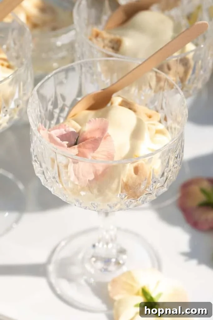 Creamy banana pudding served elegantly in a glass, topped with delicate edible flowers for a beautiful presentation.
