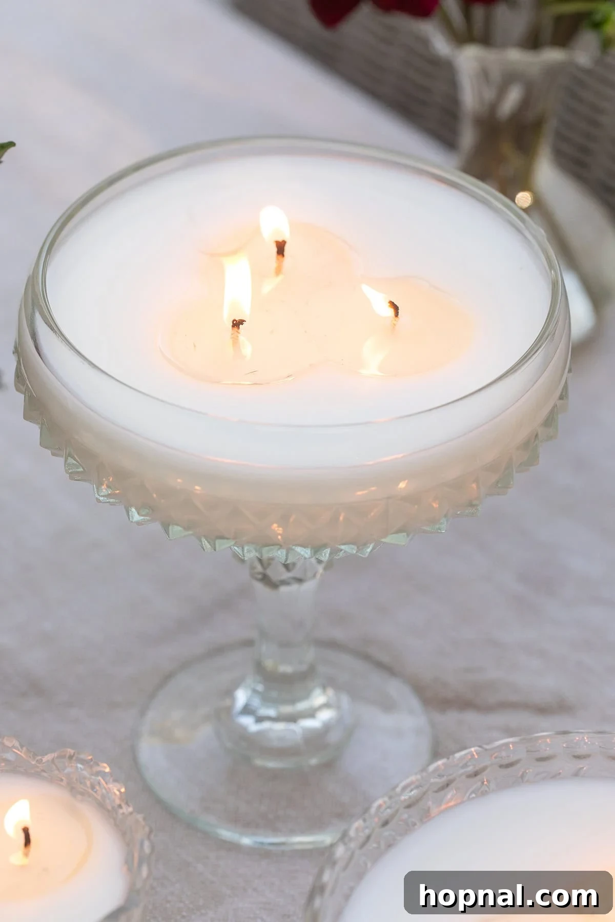Vintage lidded glass candle styled on an outdoor table.