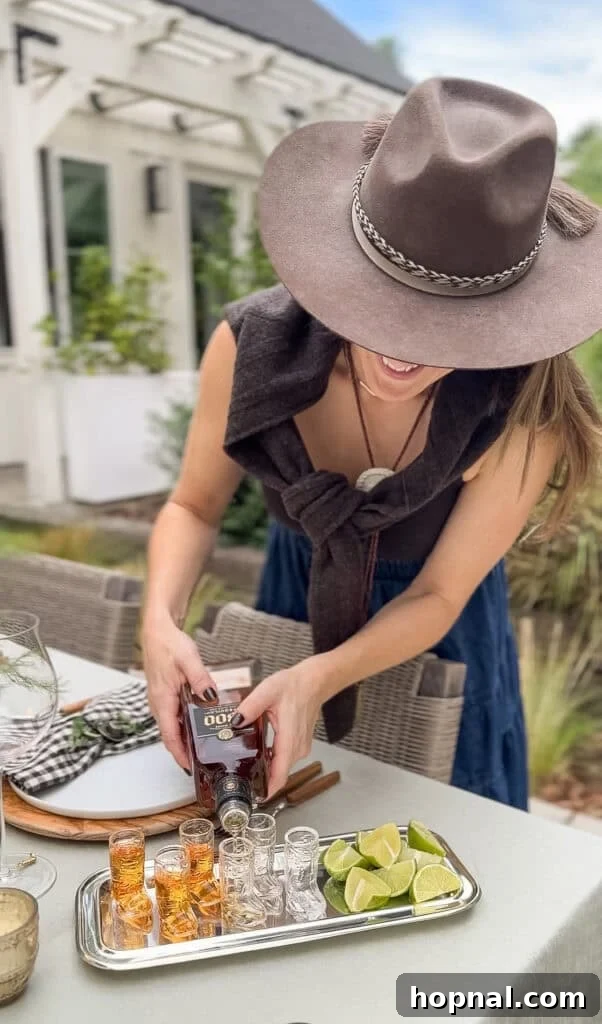 Rodeo-Themed Dinner Party Ideas: Menu, Decor & Tips 9 Eden Passante pouring tequila in a small glass cowboy boot shot glass.